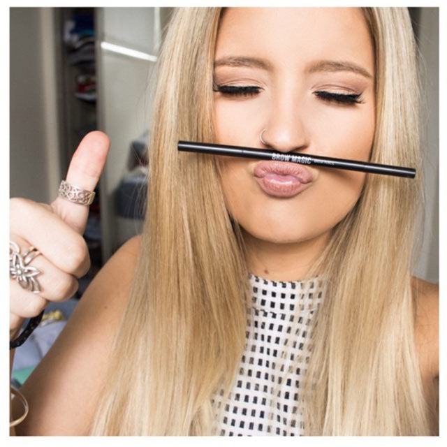 Blonde Girl Posing With Brow Magic Makeup Pencil
